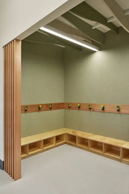 Timber-lined reading nook with bag hooks in a Gagebrook Primary School classroom