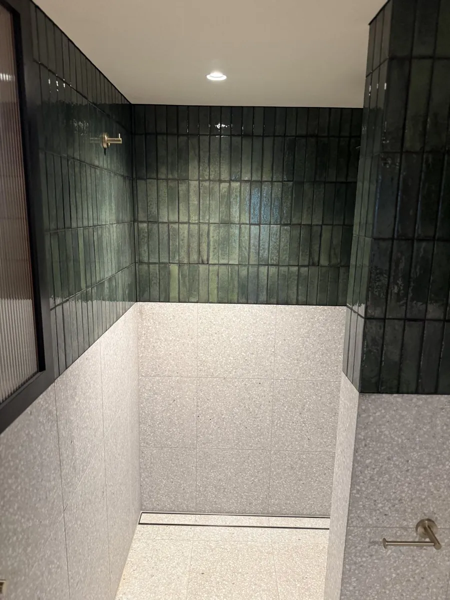 Dark green tiled shower in a renovated heritage home in Hobart