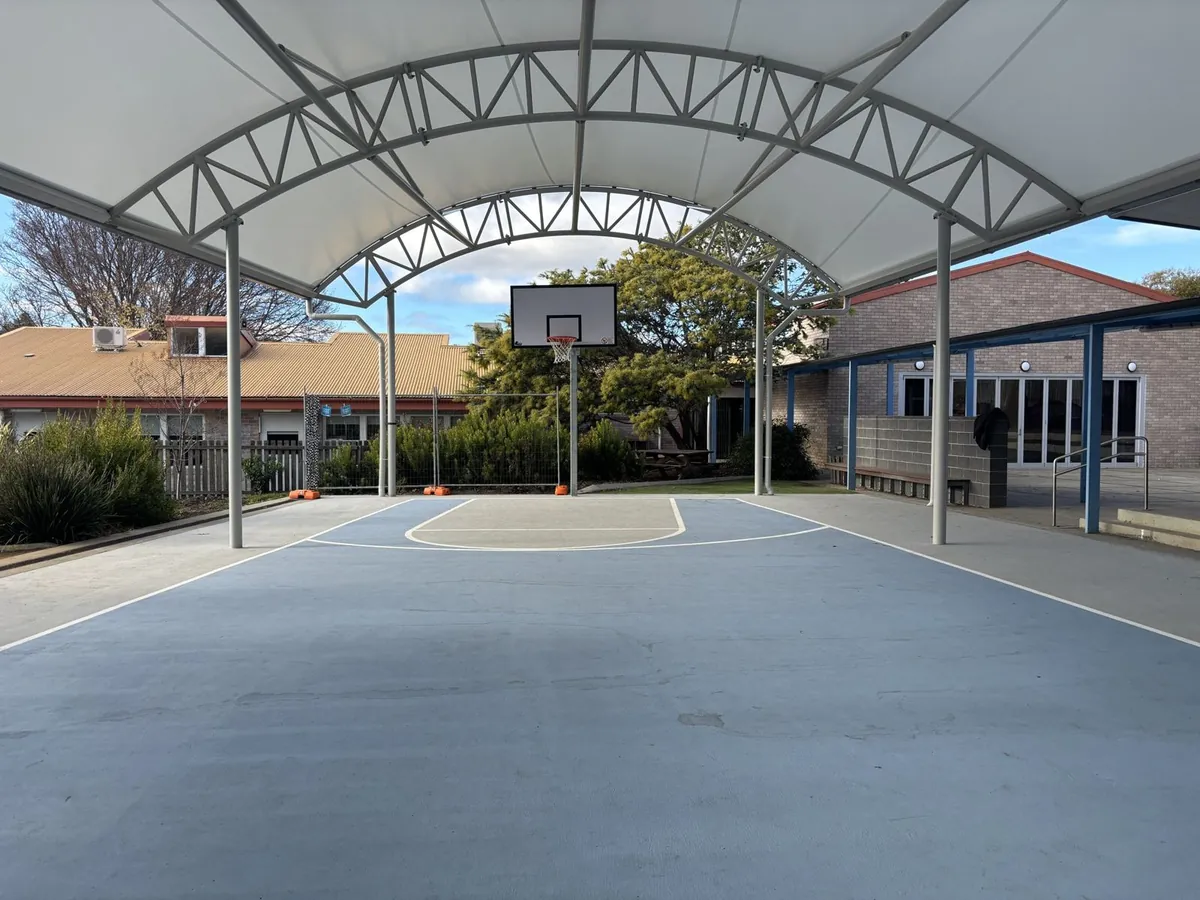 Covered basketball court with steel truss canopy at Rosetta Primary School